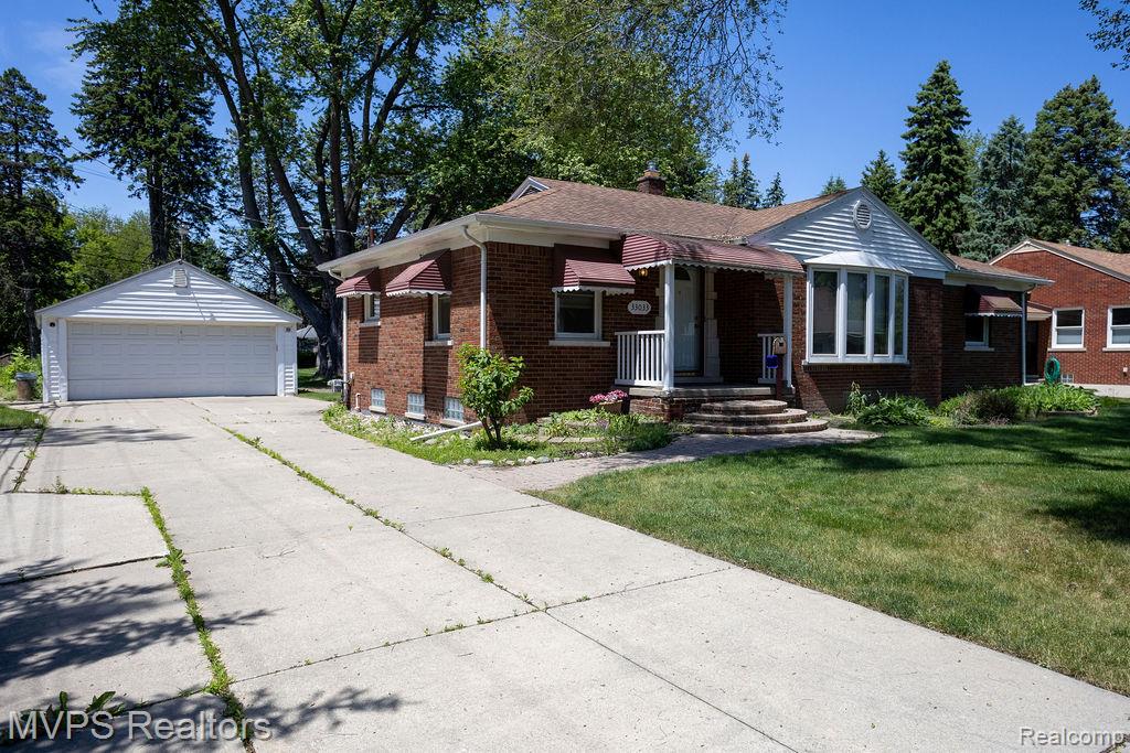 33033 Edgegrove Road Fraser, MI 48026 - Photo 2 of 20 Brick exterior residence featuring a front lawn, a multi-pane bay window, and a covered entry porch with white railings