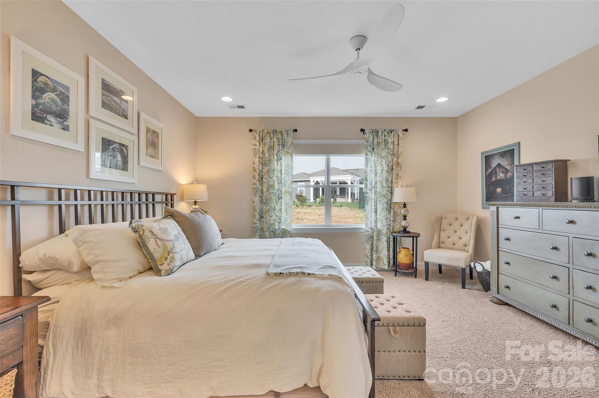 6243 Scuttle Lane Denver, NC 28037 - Photo 16 of 34 a spacious bedroom with a bed a couch and dresser