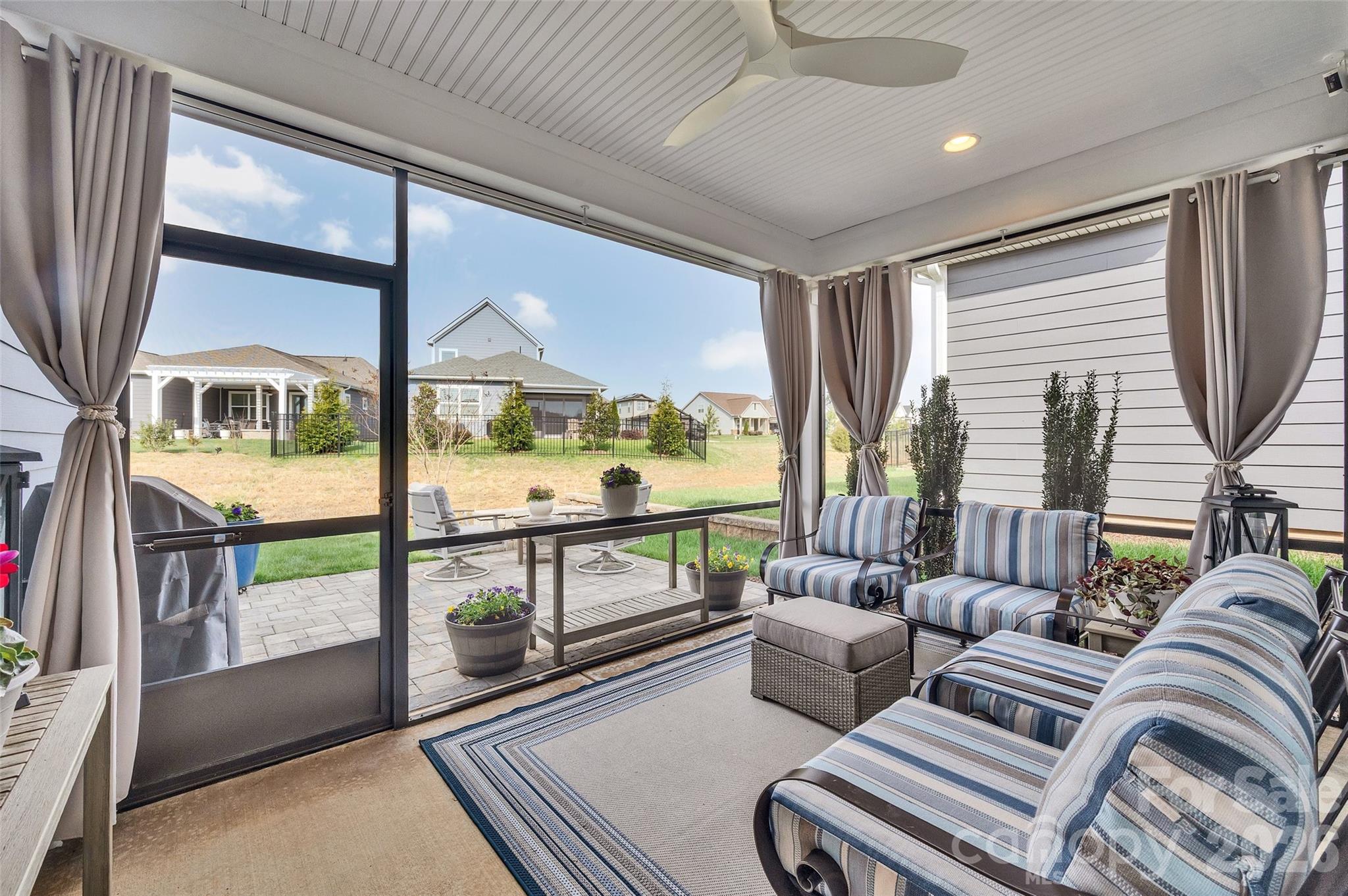 6243 Scuttle Lane Denver, NC 28037 - Photo 24 of 34 a living room with furniture and a floor to ceiling window