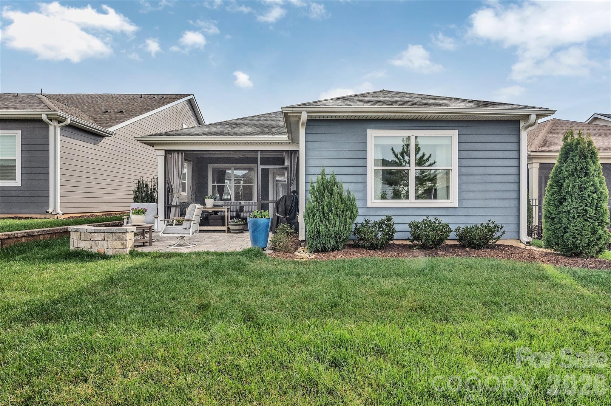 6243 Scuttle Lane Denver, NC 28037 - Photo 25 of 34 a front view of a house with a yard patio and fire pit