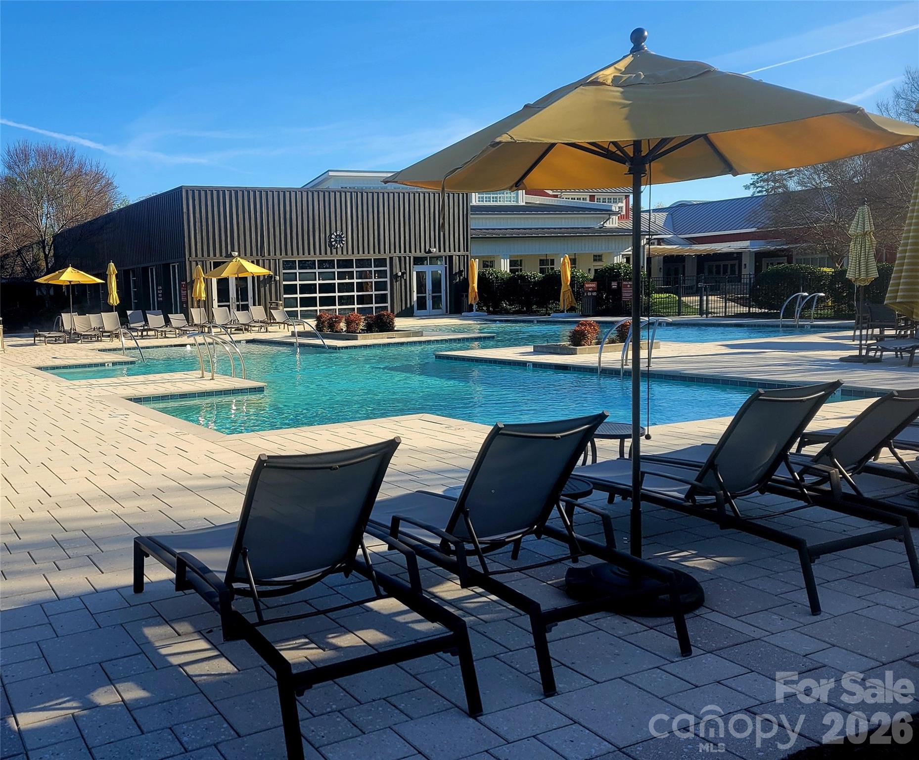 6243 Scuttle Lane Denver, NC 28037 - Photo 28 of 34 a view of a swimming pool with a table and chairs under an umbrella