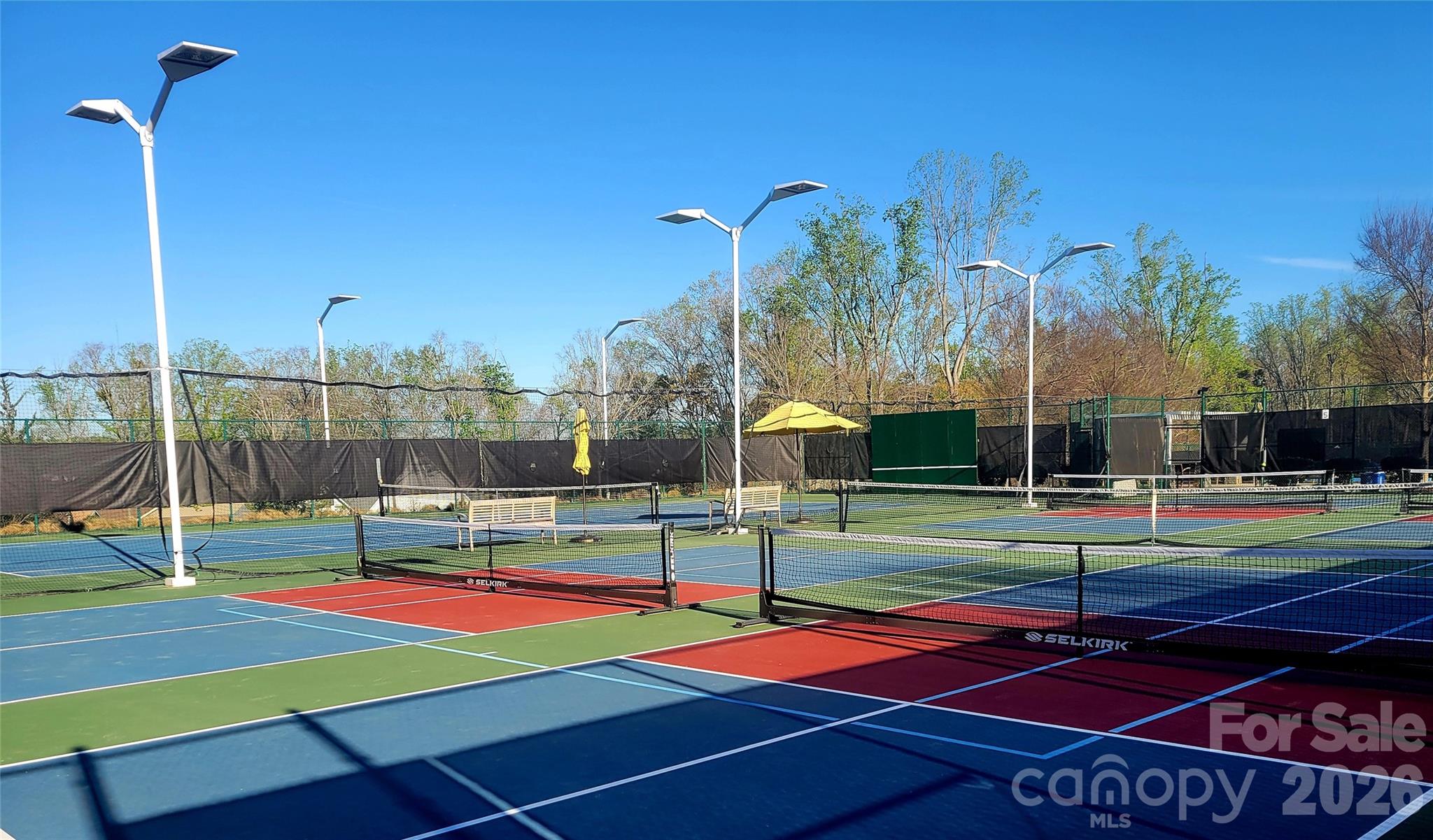 6243 Scuttle Lane Denver, NC 28037 - Photo 29 of 34 a view of a tennis ground with large trees