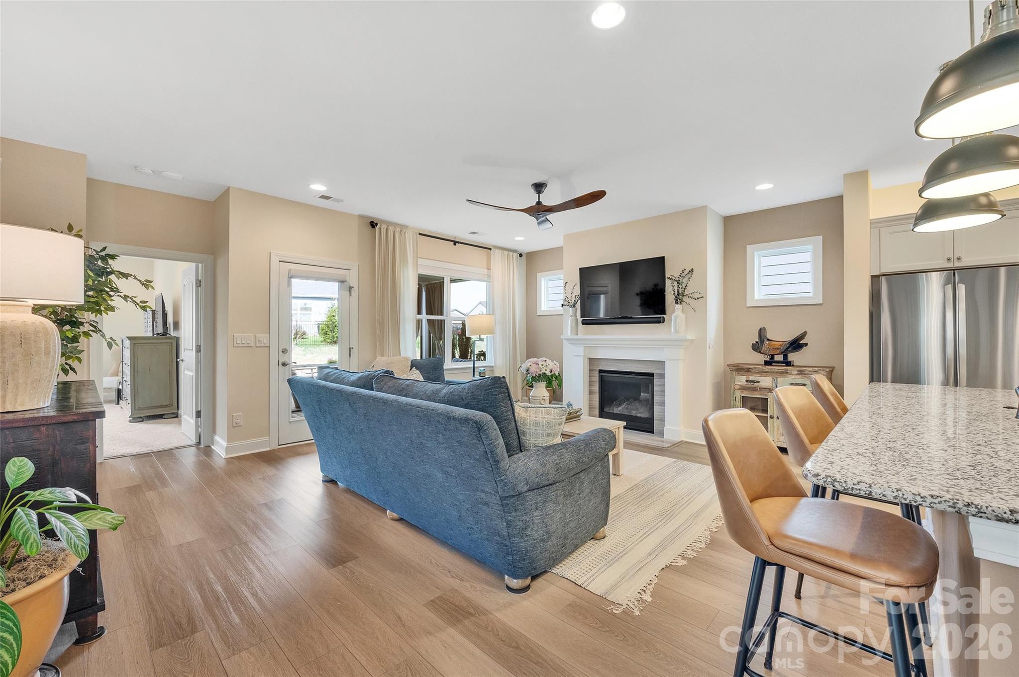 6243 Scuttle Lane Denver, NC 28037 - Photo 9 of 34 a living room with furniture a fireplace a flat screen tv and wooden floor