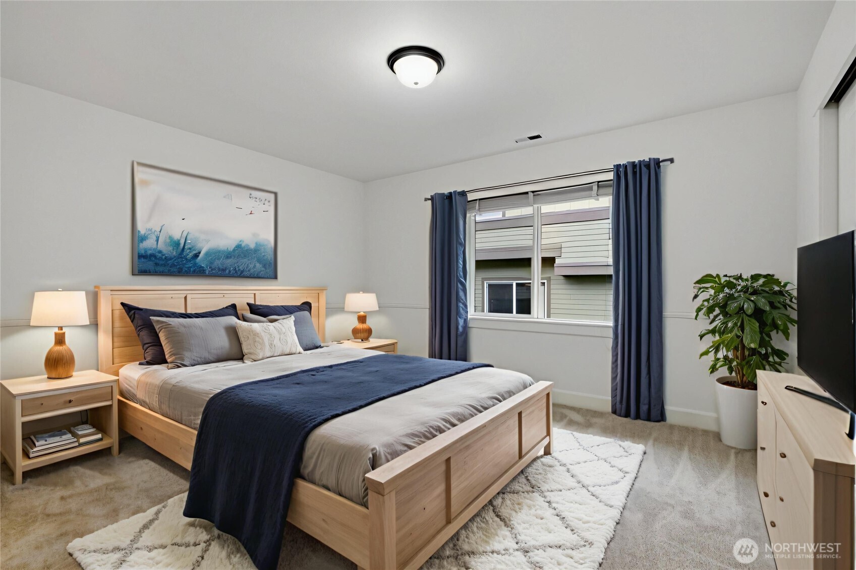 2115 201st Place Southeast, Unit B2 Bothell, WA 98012 - Photo 11 of 24 a bedroom with a bed and a potted plant