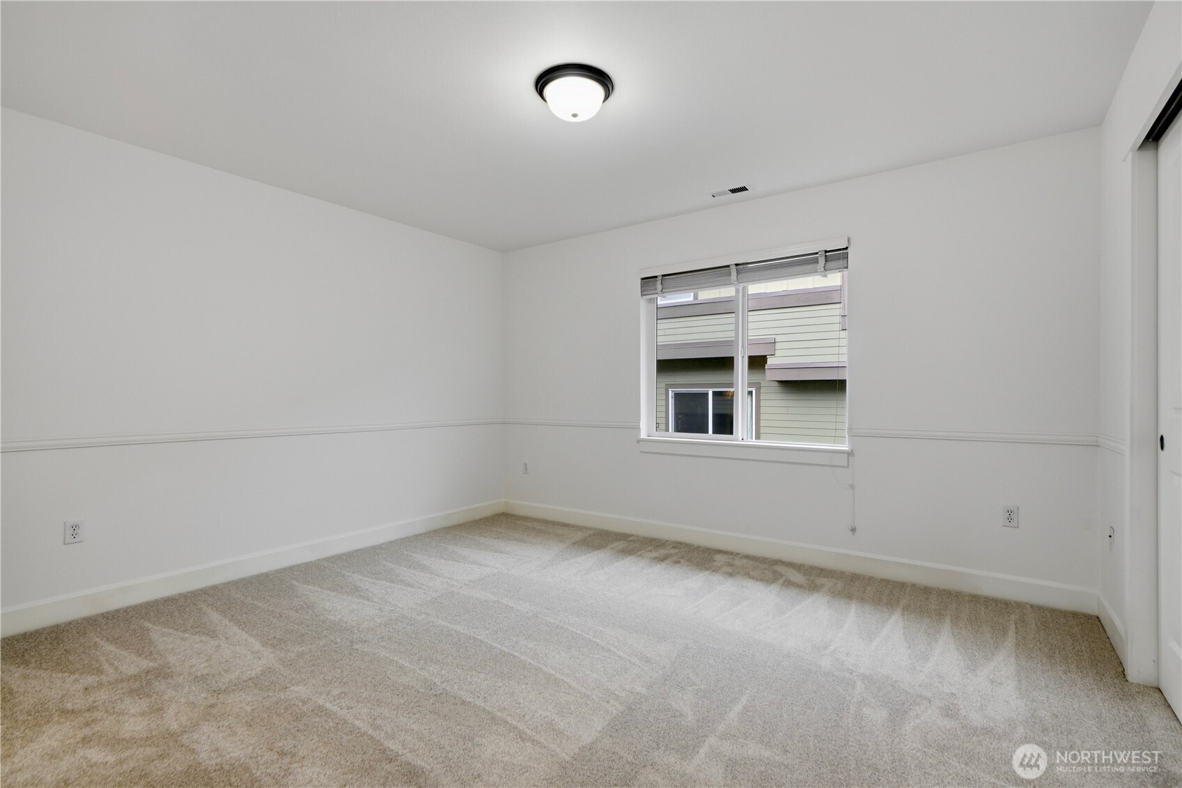 2115 201st Place Southeast, Unit B2 Bothell, WA 98012 - Photo 13 of 24 an empty room with cabinet and windows