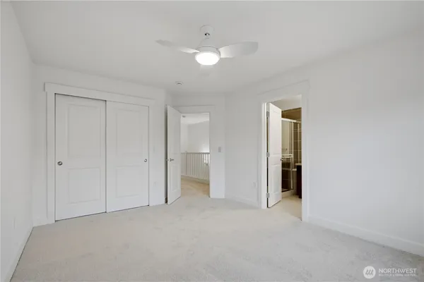 a view of an empty room and a bathroom