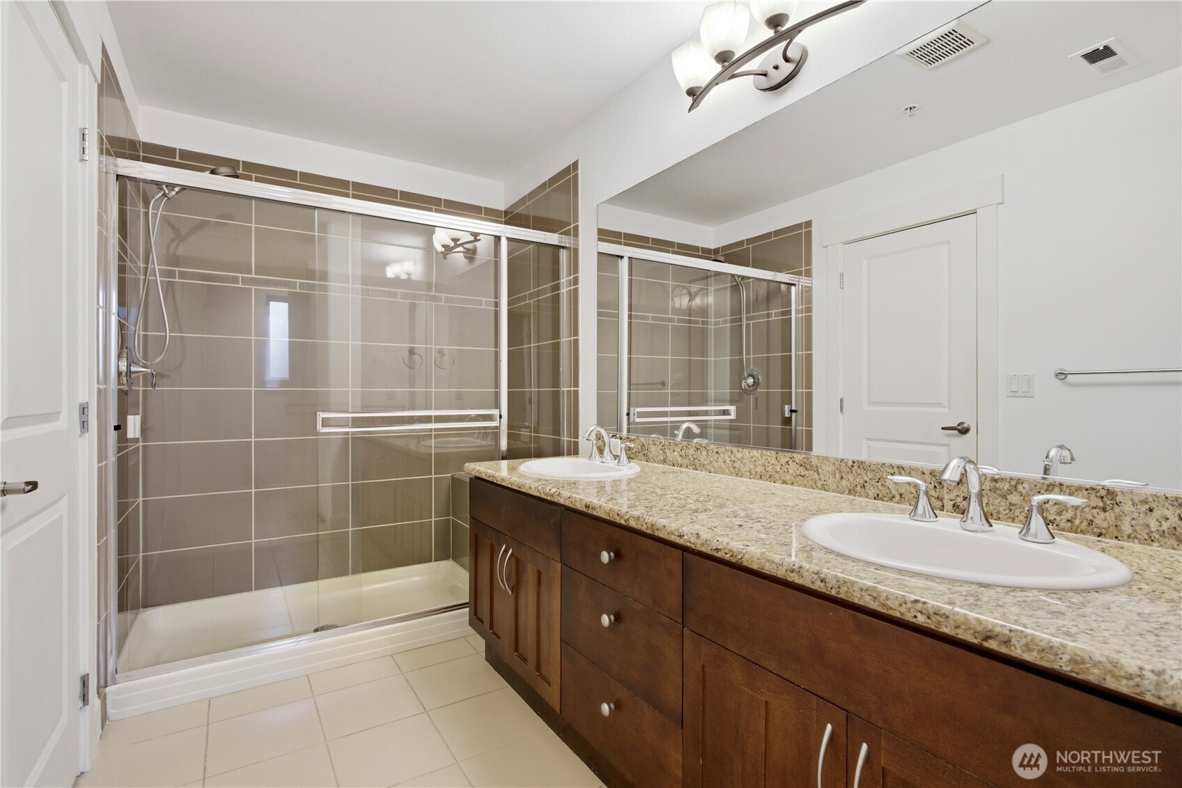 2115 201st Place Southeast, Unit B2 Bothell, WA 98012 - Photo 18 of 24 a bathroom with a granite countertop sink a mirror and a bathtub