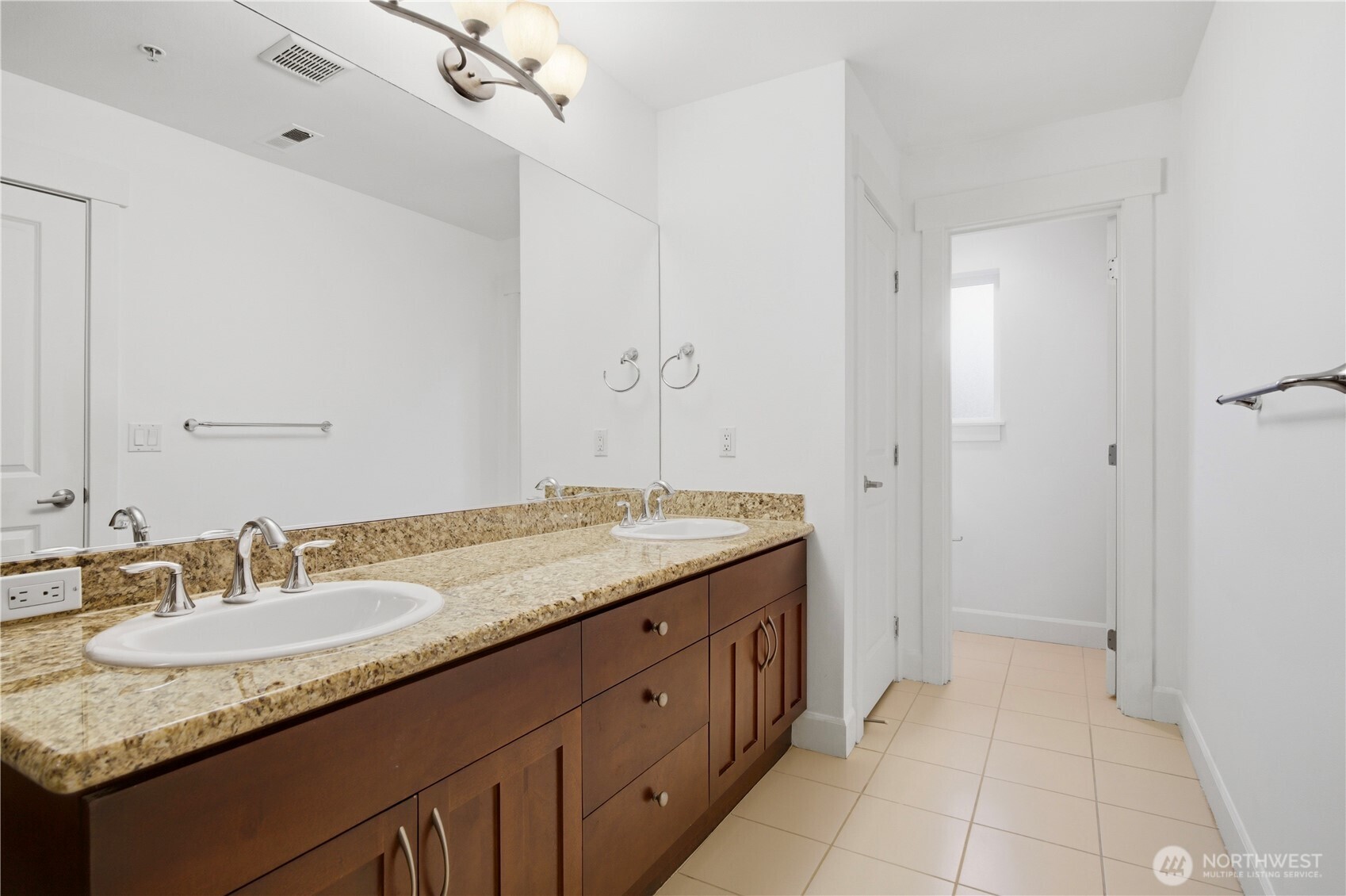 2115 201st Place Southeast, Unit B2 Bothell, WA 98012 - Photo 19 of 24 a bathroom with a granite countertop sink and a mirror