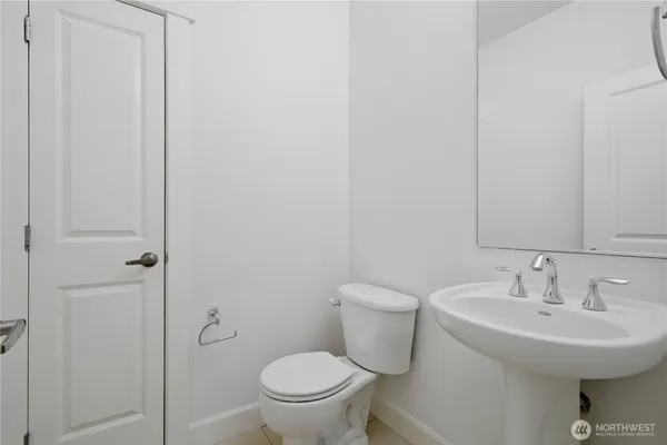 a bathroom with a sink toilet and a mirror
