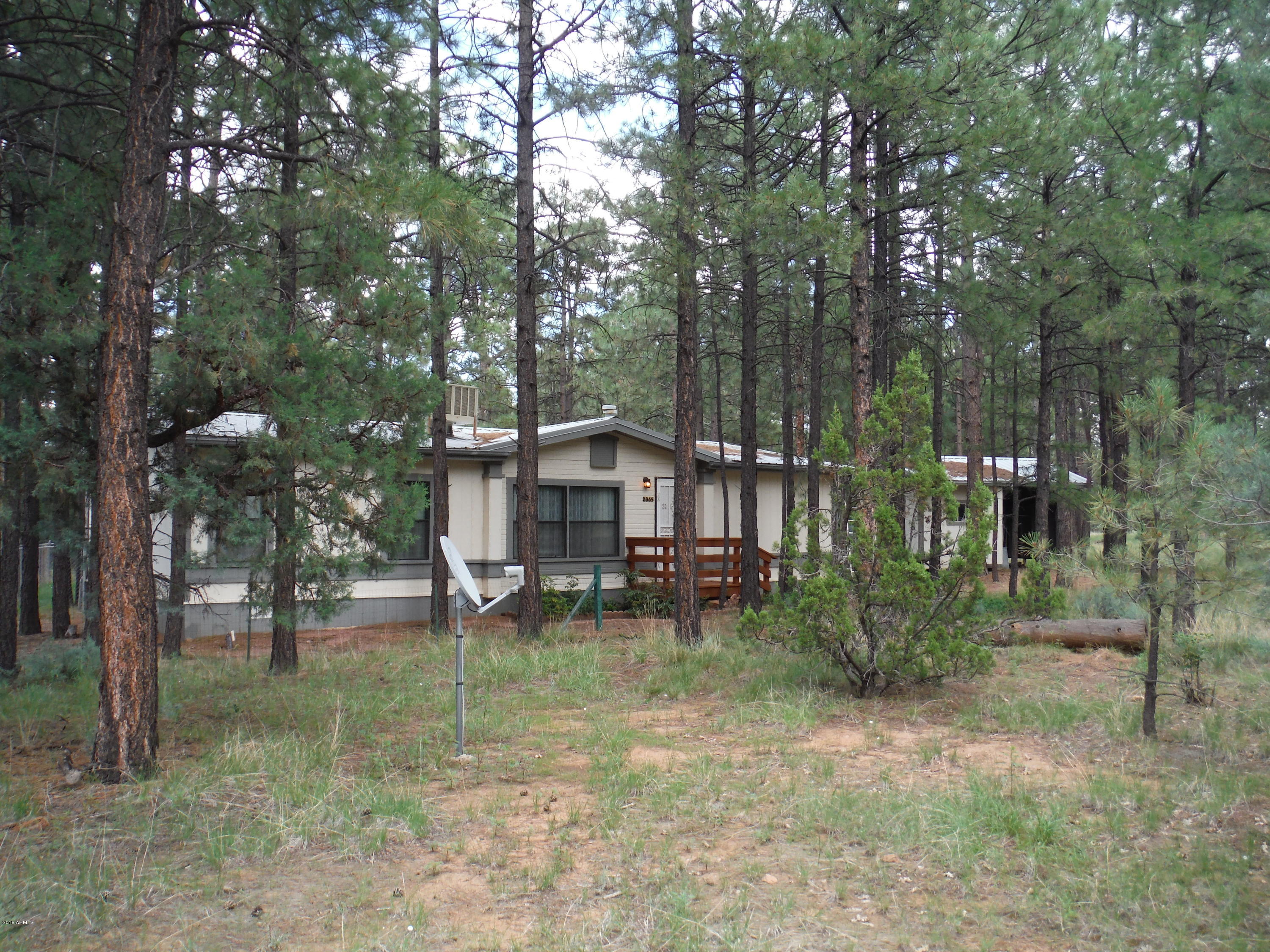 2865 Cattle Trail Road Overgaard, AZ 85933 - Photo 1 of 28 a backyard of a house with table and chairs