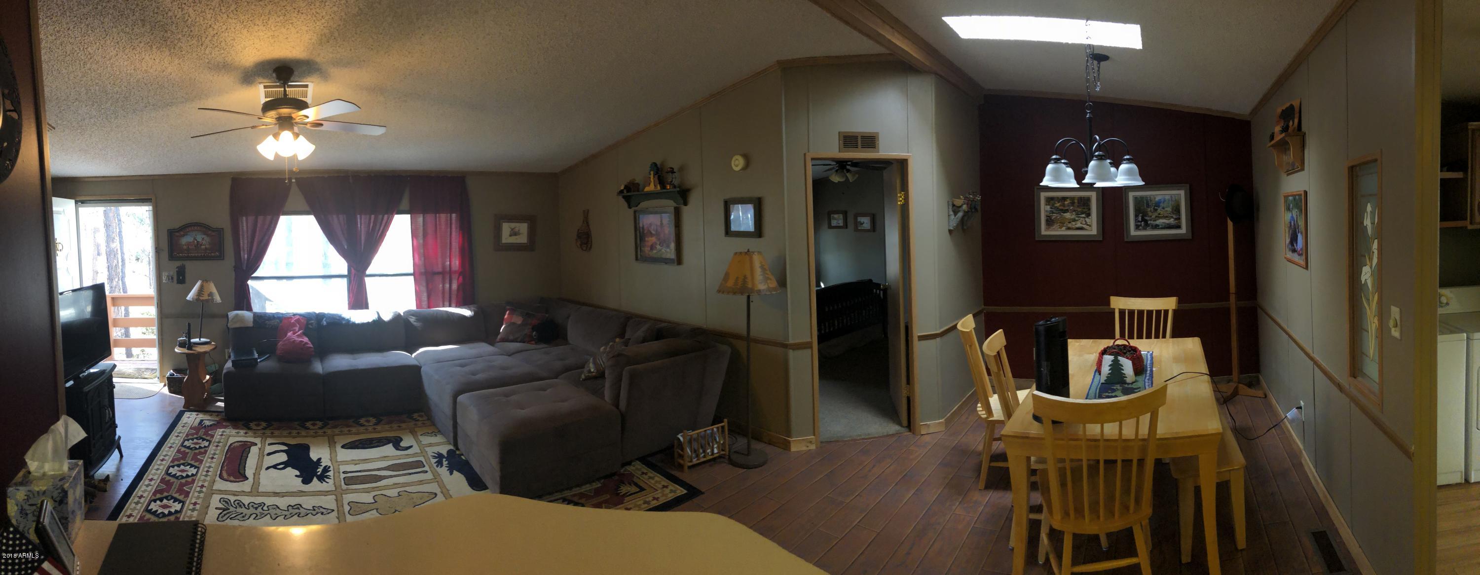 2865 Cattle Trail Road Overgaard, AZ 85933 - Photo 16 of 28 a living room with furniture and chandelier