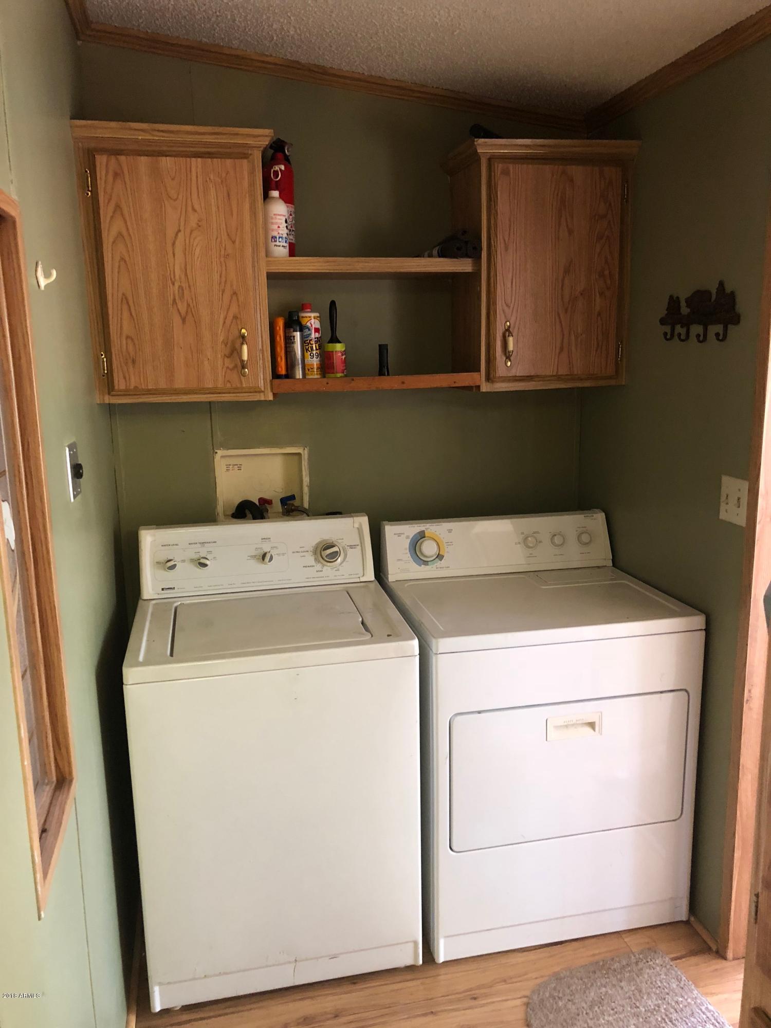 2865 Cattle Trail Road Overgaard, AZ 85933 - Photo 17 of 28 a utility room with dryer and washer