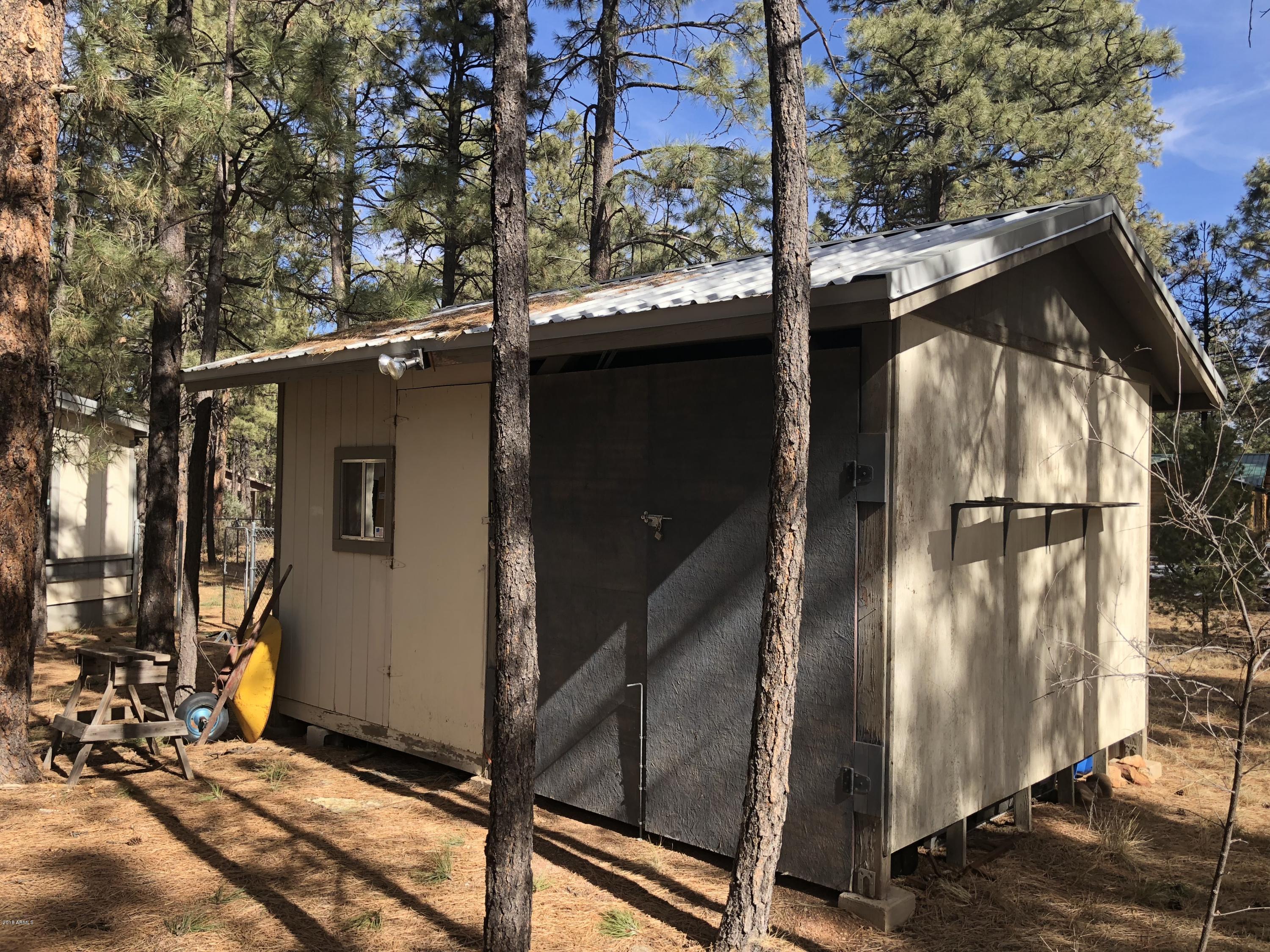 2865 Cattle Trail Road Overgaard, AZ 85933 - Photo 26 of 28 a view of a house with a door