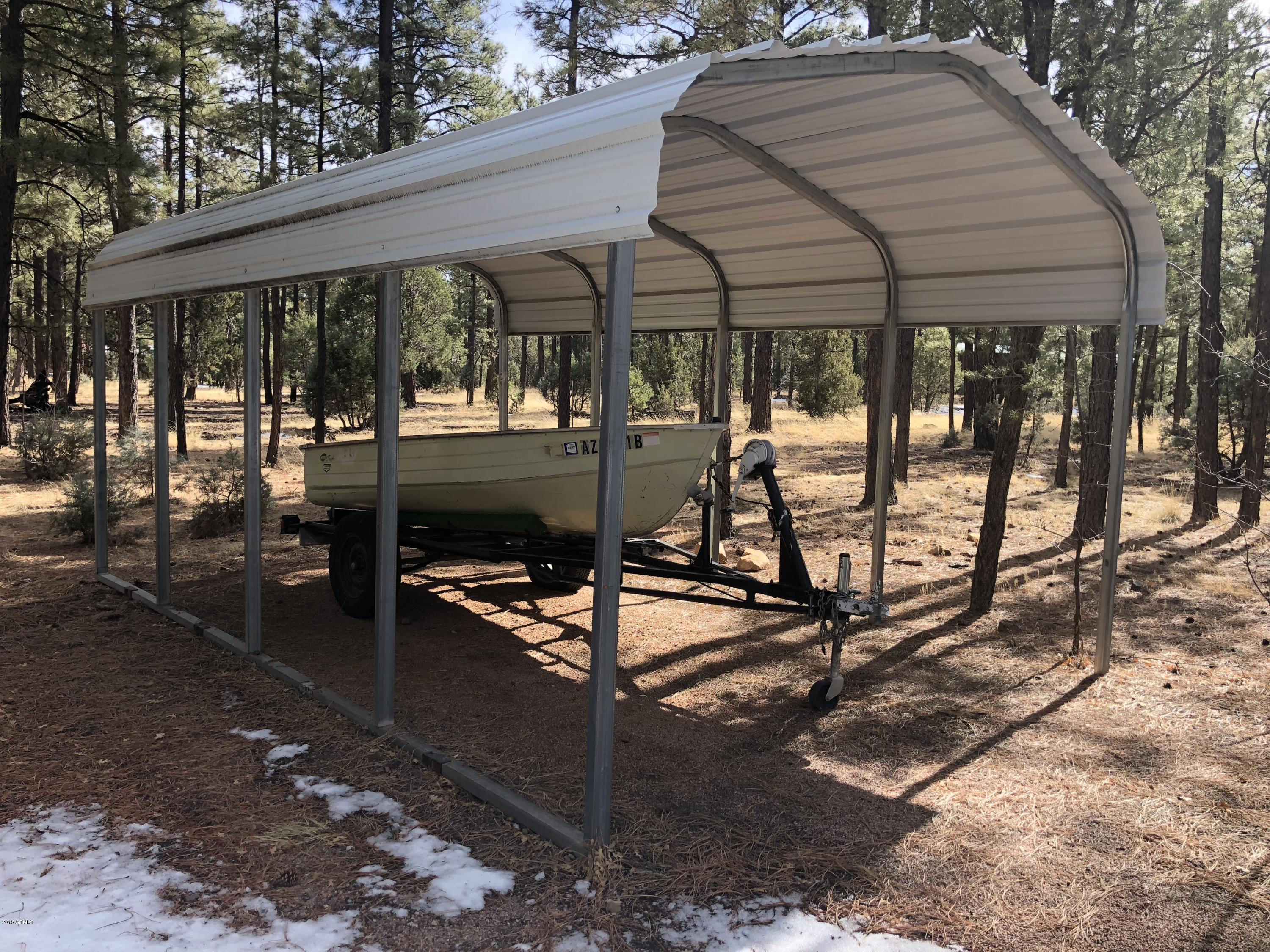 2865 Cattle Trail Road Overgaard, AZ 85933 - Photo 27 of 28 a view of a patio with table and chairs under an umbrella