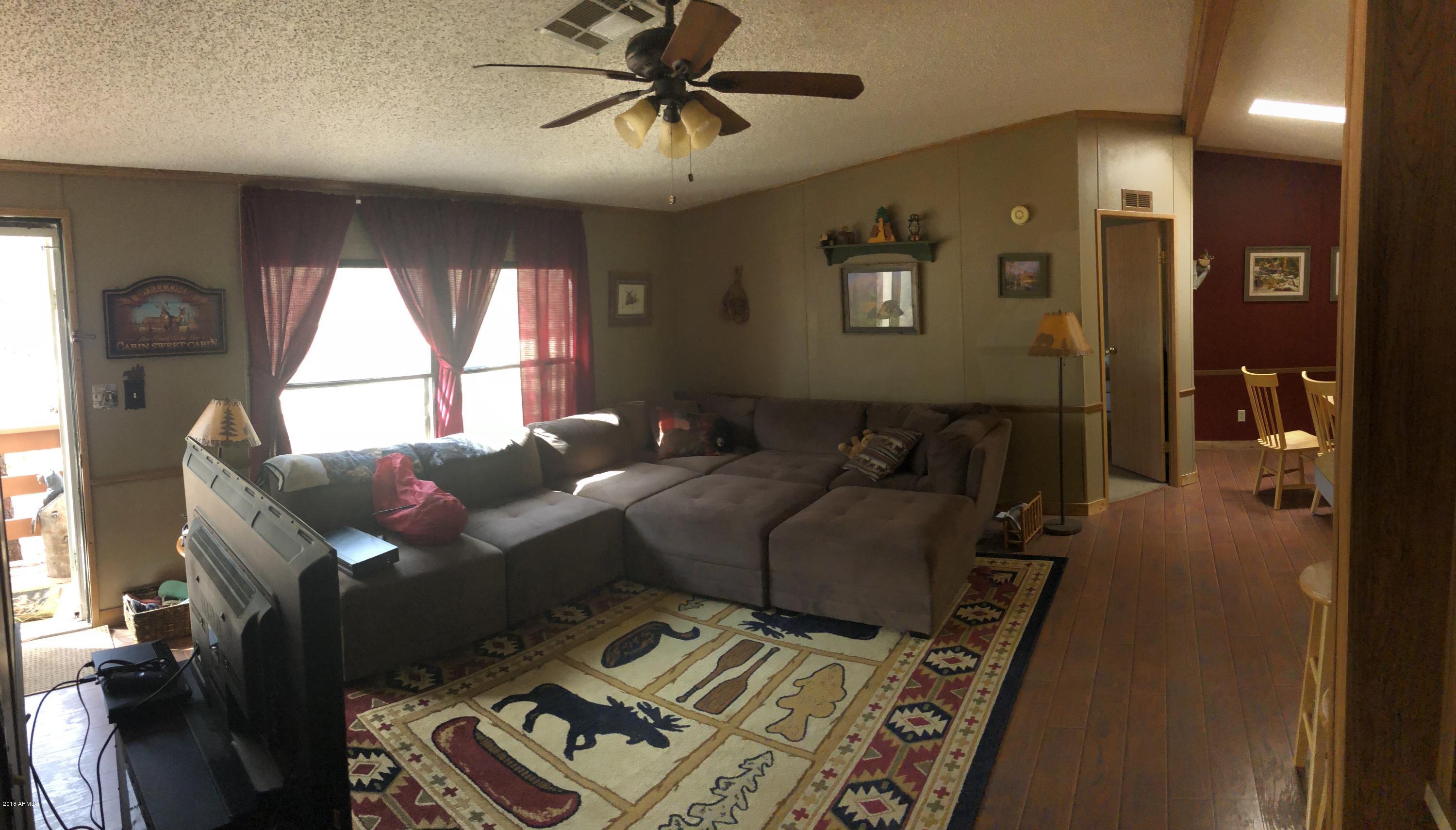 2865 Cattle Trail Road Overgaard, AZ 85933 - Photo 9 of 28 a bed room with a bed and a window