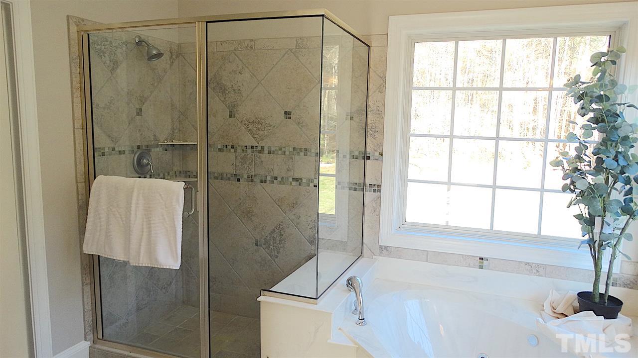 10404 Veasey Mill Road Raleigh, NC 27615 - Photo 12 of 30 a bathroom with a tub and a shower