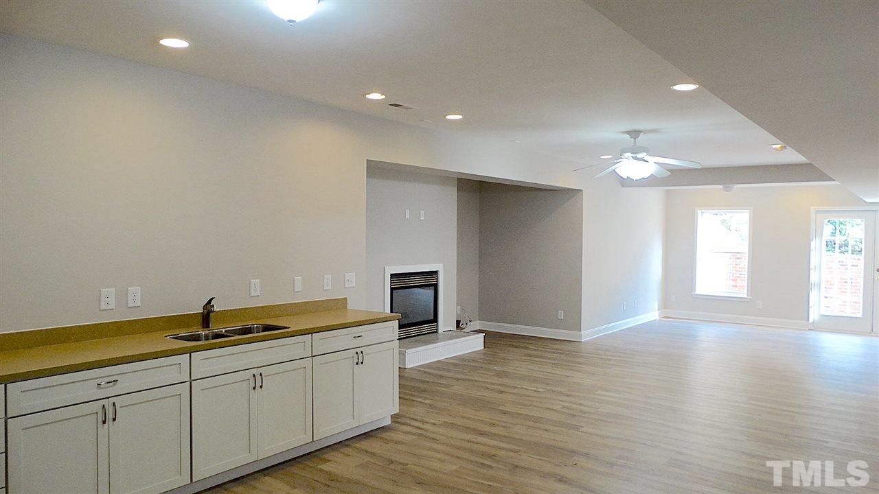 10404 Veasey Mill Road Raleigh, NC 27615 - Photo 20 of 30 a hall with cabinets and wooden floor