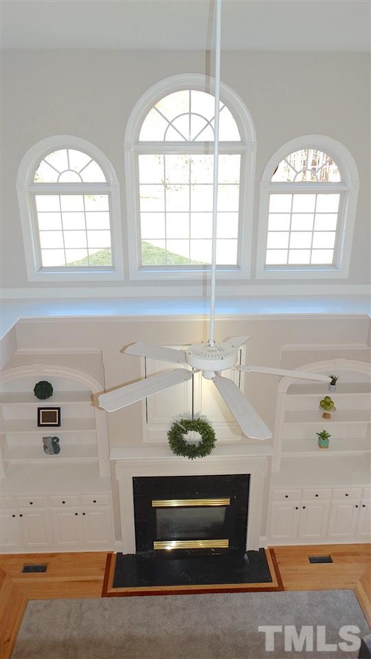 10404 Veasey Mill Road Raleigh, NC 27615 - Photo 3 of 30 an empty room with windows and cabinet
