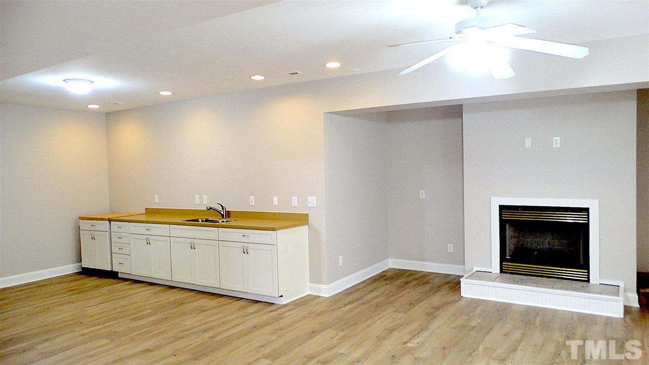10404 Veasey Mill Road Raleigh, NC 27615 - Photo 21 of 30 a view of an empty room with a fireplace and a window