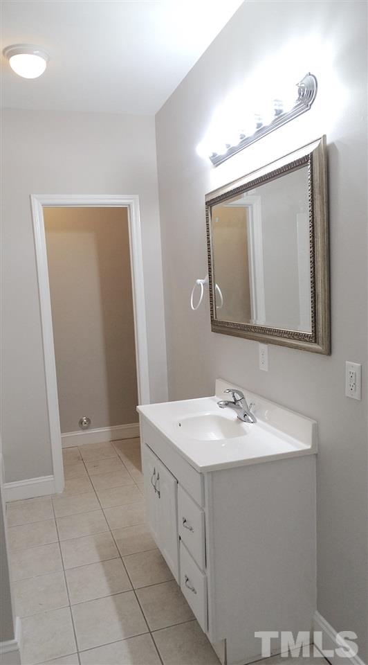 10404 Veasey Mill Road Raleigh, NC 27615 - Photo 23 of 30 a bathroom with a sink vanity and mirror