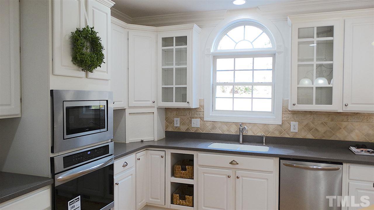 10404 Veasey Mill Road Raleigh, NC 27615 - Photo 4 of 30 a kitchen with a sink and a window