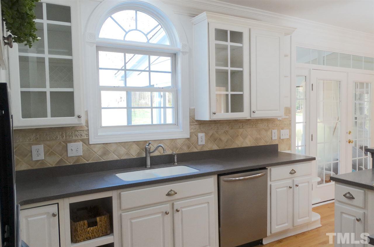 10404 Veasey Mill Road Raleigh, NC 27615 - Photo 5 of 30 a kitchen with stainless steel appliances granite countertop white cabinets and a granite counter tops