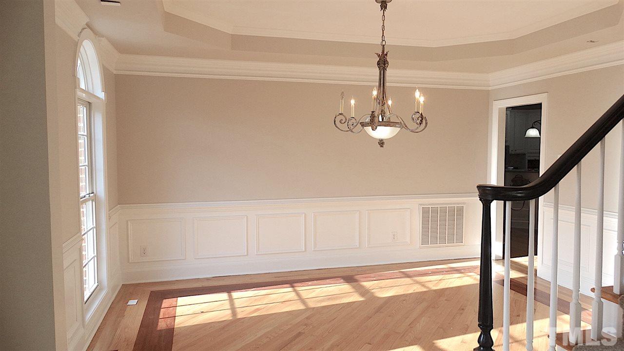 10404 Veasey Mill Road Raleigh, NC 27615 - Photo 8 of 30 a view of a room with wooden floor chandeliers and kitchen view