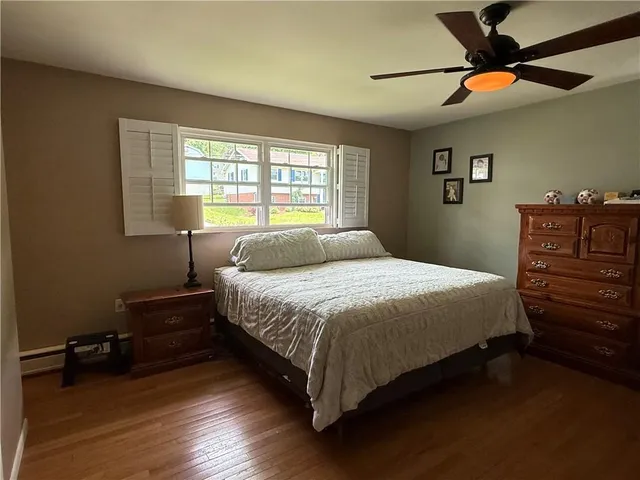 a bedroom with a bed and a ceiling fan