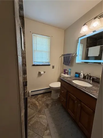 a bathroom with a toilet sink and mirror