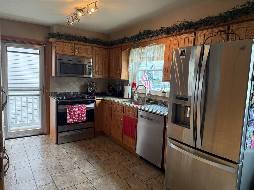 570 Hancock Street Clymer, PA 15728 - Photo 2 of 33 a kitchen with stainless steel appliances granite countertop a refrigerator a stove a sink and a microwave