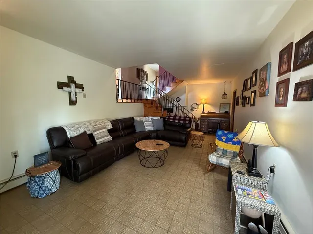 a living room with furniture and a lamp