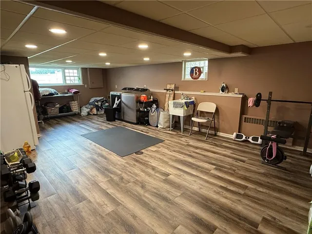 a view of a room with furniture and a refrigerator