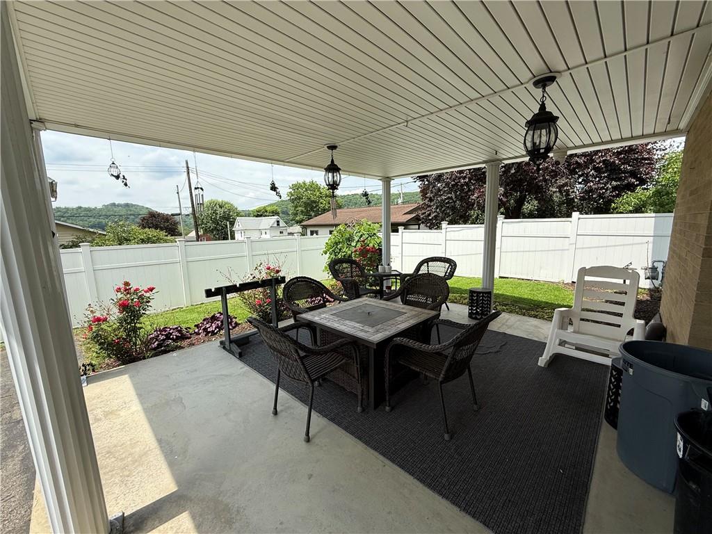 570 Hancock Street Clymer, PA 15728 - Photo 28 of 33 a view of a patio with table and chairs potted plants with floor to ceiling window