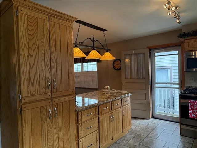 a kitchen that has a sink a stove and a refrigerator