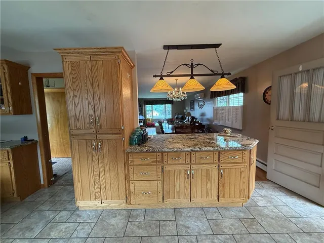 a view of a kitchen with cabinets and refrigerator