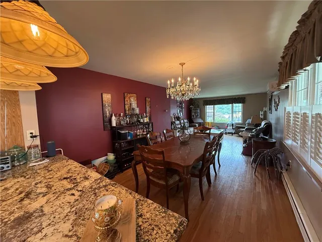 a view of a dining room with furniture and chandelier