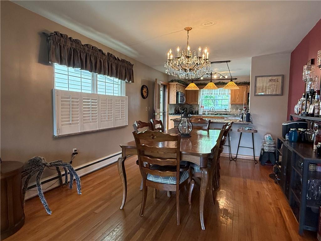 570 Hancock Street Clymer, PA 15728 - Photo 7 of 33 a view of a dining room with furniture a chandelier and wooden floor