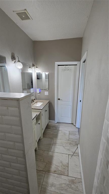 708 Fortanini Circle Ocoee, FL 34761 - Photo 14 of 32 a kitchen with a sink and a refrigerator