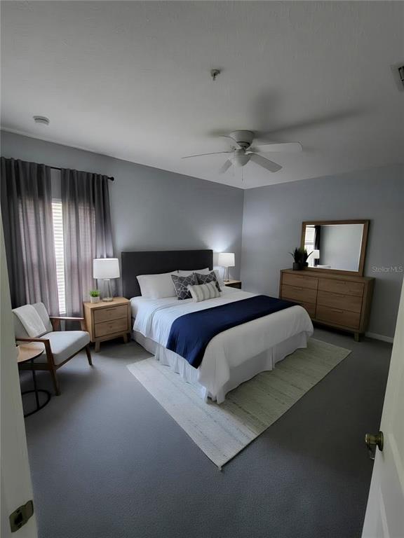 708 Fortanini Circle Ocoee, FL 34761 - Photo 15 of 32 a bedroom with a bed and a chandelier