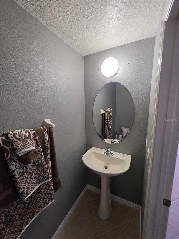 708 Fortanini Circle Ocoee, FL 34761 - Photo 18 of 32 a bathroom with a sink and a mirror