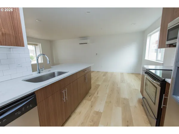a kitchen with a sink a microwave a stove and refrigerator
