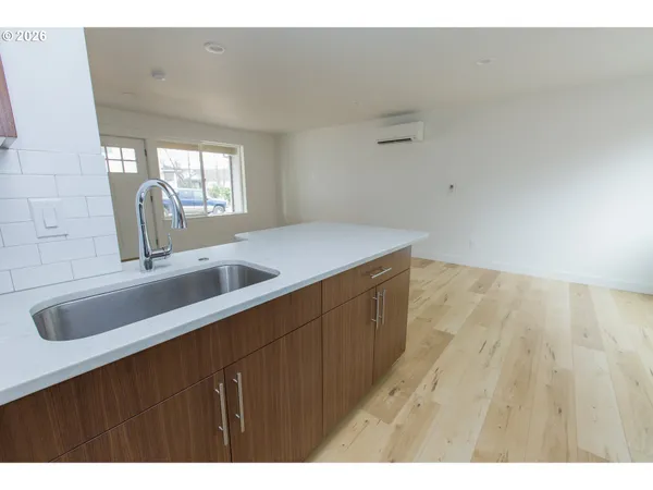 a kitchen with a sink cabinets and a window