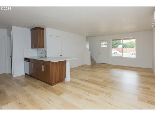 a view of kitchen with wooden floor and windows