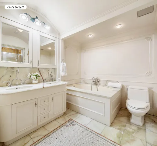 a bathroom with a toilet sink and mirror