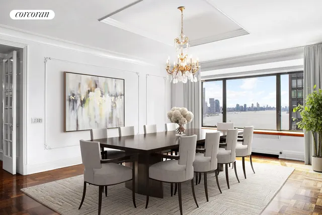 a dining room with furniture a large window and wooden floor