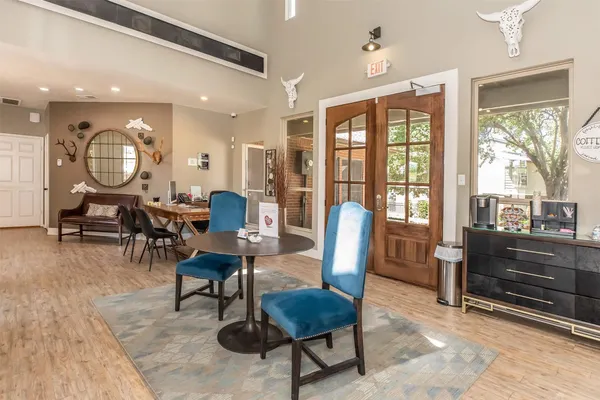 a living room with furniture a dining table and a large window