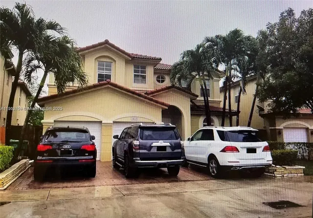 a view of cars parked in front of a house