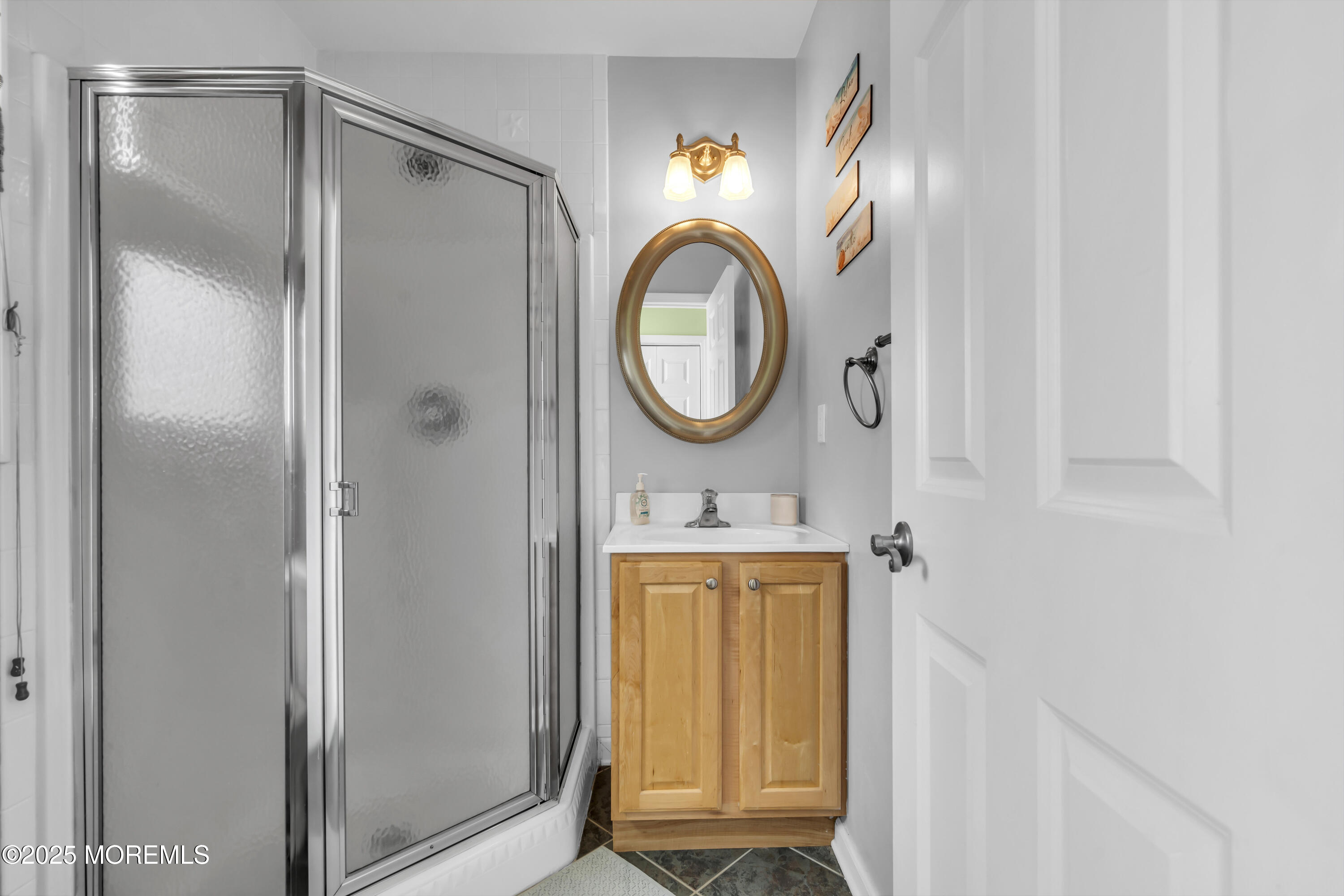 39 East Penguin Way Lavallette, NJ 08735 - Photo 22 of 29 a bathroom with a sink a mirror and a shower