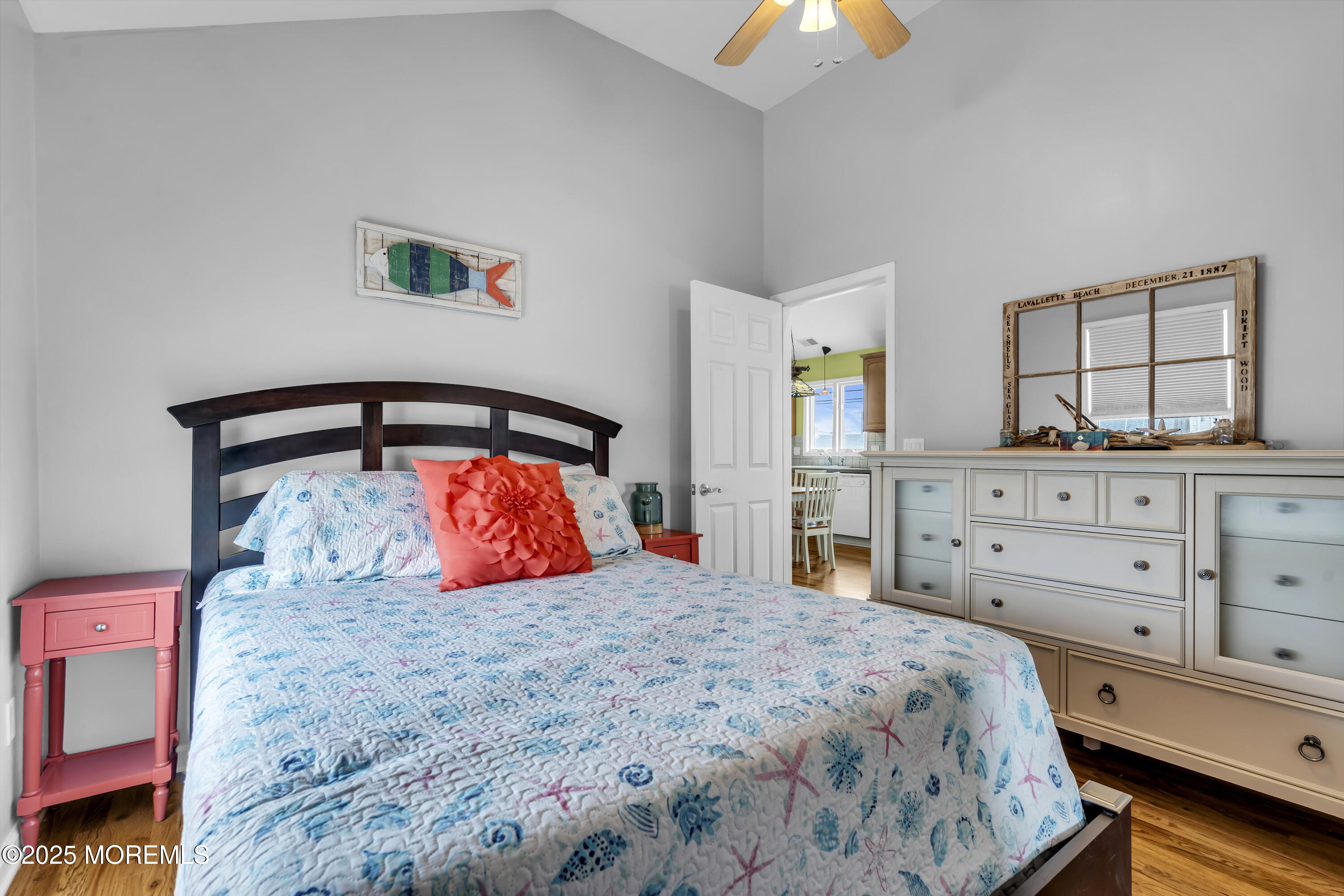 39 East Penguin Way Lavallette, NJ 08735 - Photo 24 of 29 a bedroom with a large bed and a chandelier