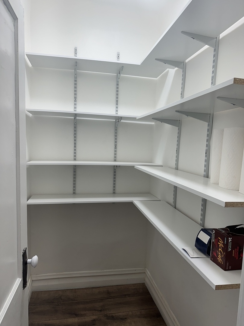 8634 South Carpenter Street Chicago, IL 60620 - Photo 15 of 28 a view of walk in closet with empty racks